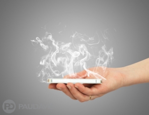 Hand holding smart phone with white smoke