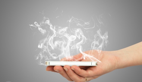 Hand holding smart phone with white smoke